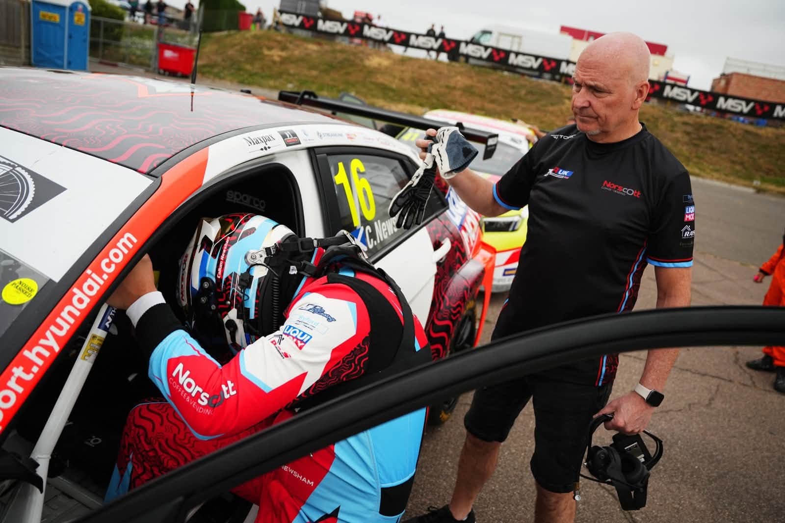 Callum Newsham climbing onboard his Hyundai Elantra TCR UK Car in his bespoke Torq Racecraft