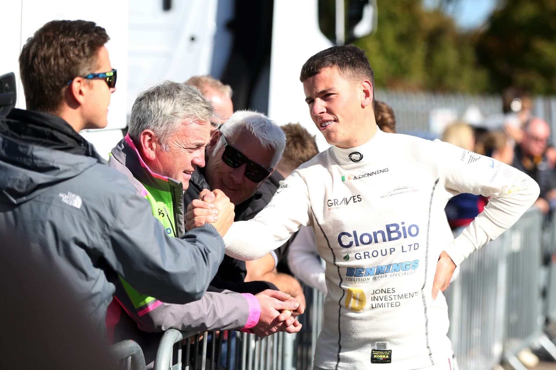 Driver wearing a customised white Torq Nomex top at the circuit.